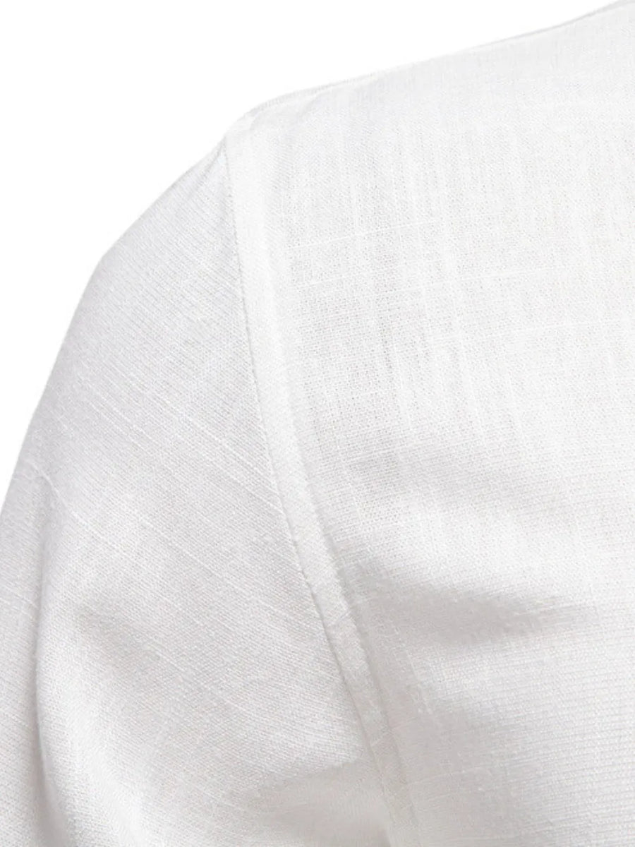 White linen shirt detail showing shoulder seam and textured fabric.