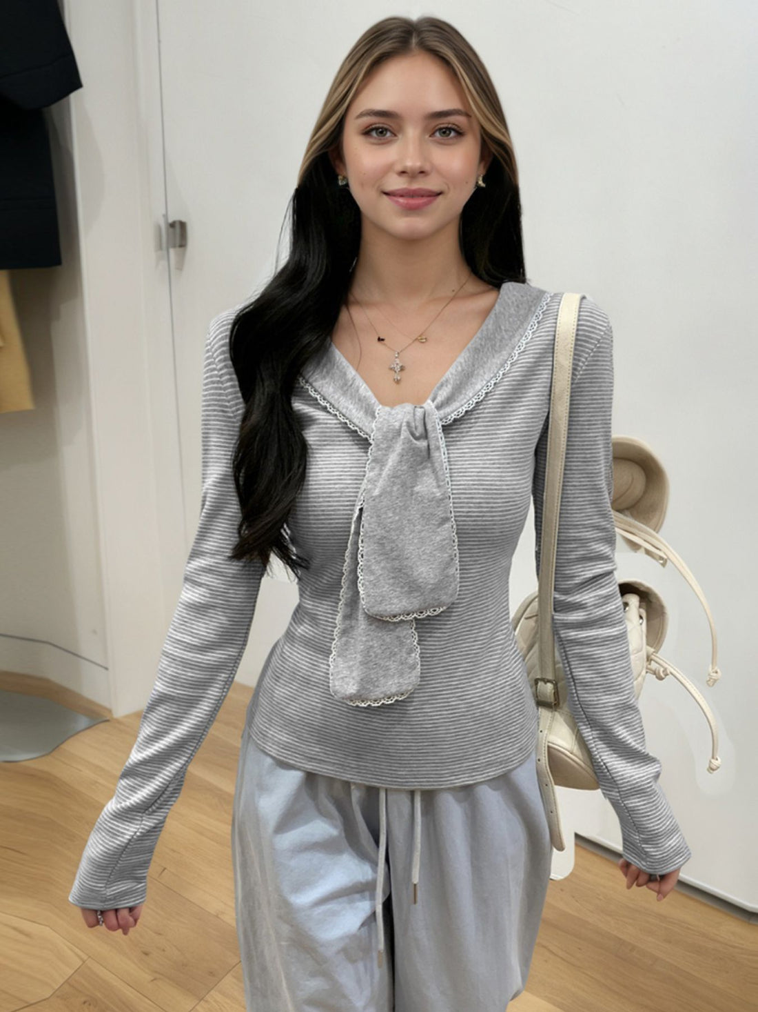 Gray striped ribbed long sleeve top with lace trim and bow detail