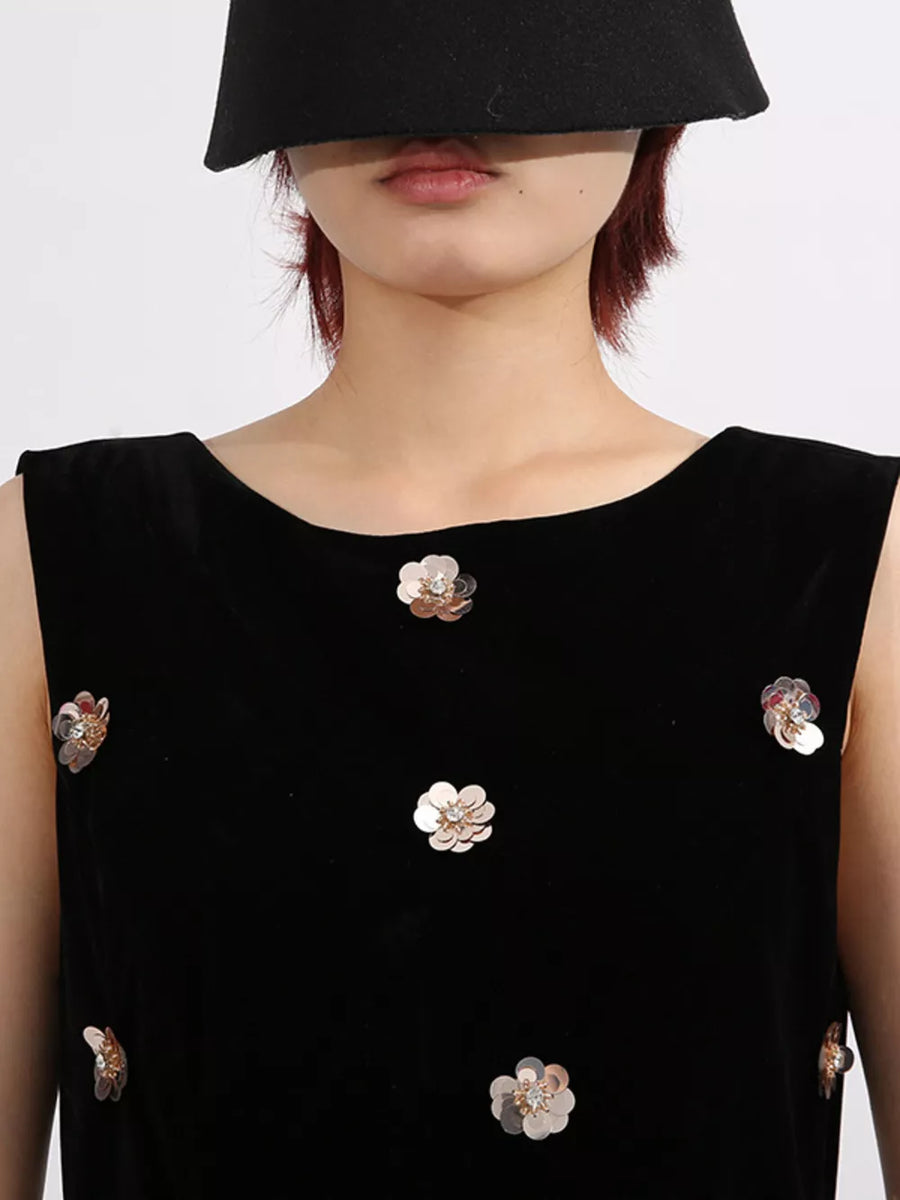 Black velvet sleeveless dress with scattered floral sequin embellishments.