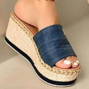 Dark blue textured platform slides with espadrille wedge and metallic detail.