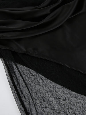 Black midi skirt with sheer lace panel detail and draped satin overlay.