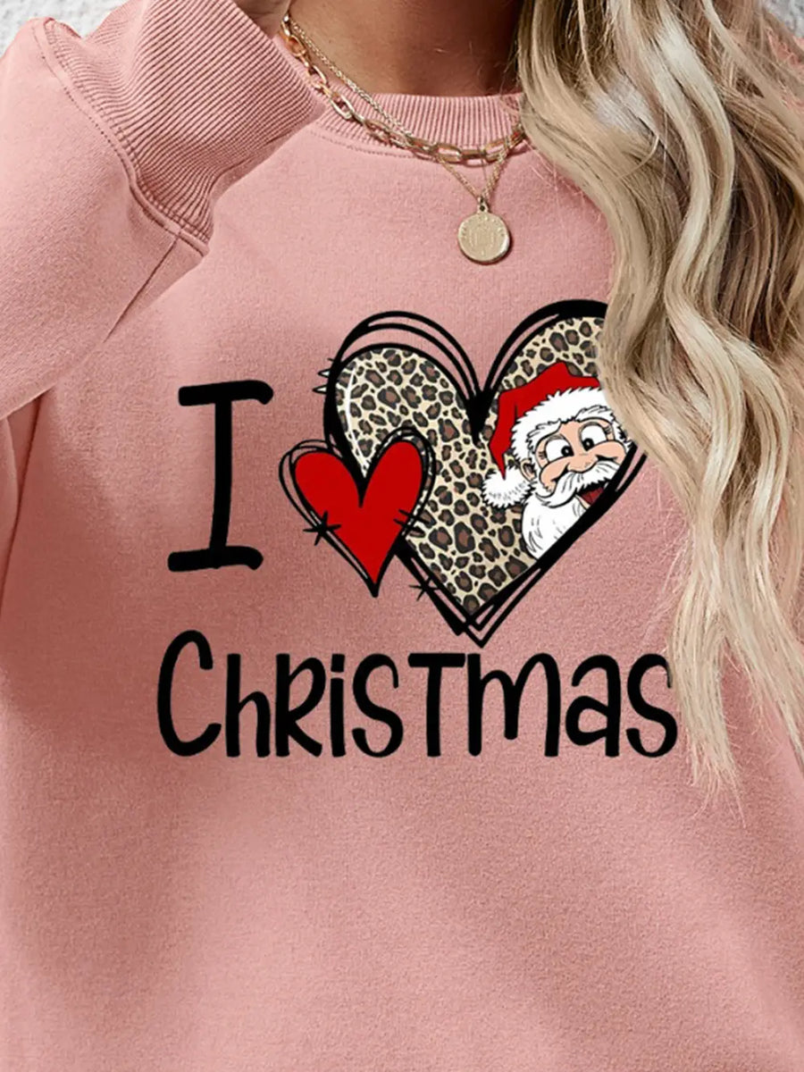 Blush pink crewneck sweatshirt with festive heart graphic and Santa detail.