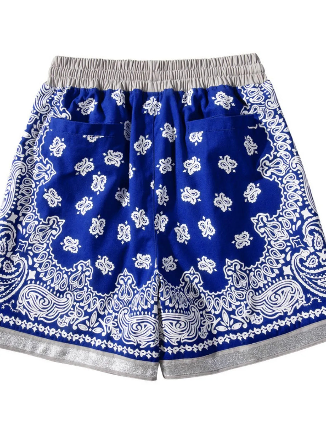 Royal blue bandana print sport shorts with metallic trim and elastic waistband.