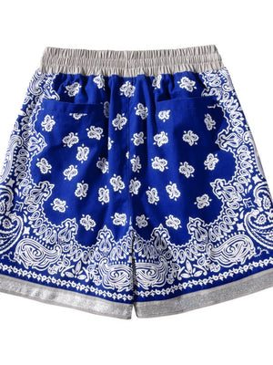 Royal blue bandana print sport shorts with metallic trim and elastic waistband.
