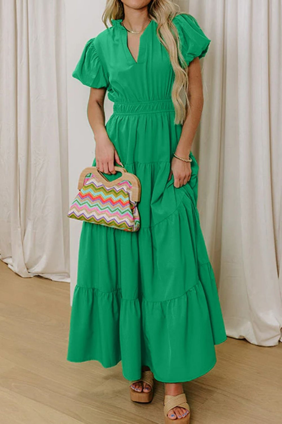 Green maxi dress with puff sleeves, V-neck, tiered skirt, and cinched waist.