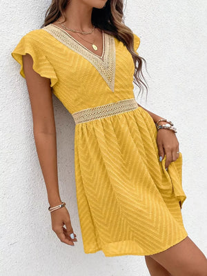 Chevron textured yellow mini dress with V-neck and lace trim