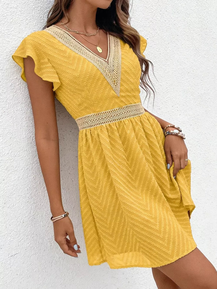Chevron textured yellow mini dress with V-neck and lace trim