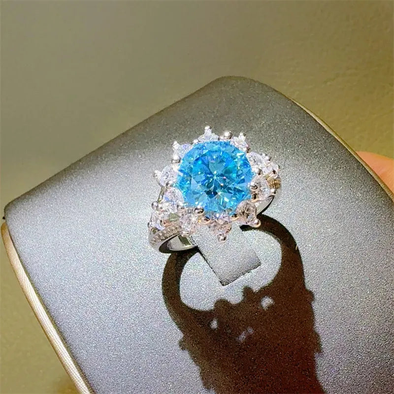 Celestial Bloom Ring in Sterling Silver with a large blue stone and surrounding white stones.