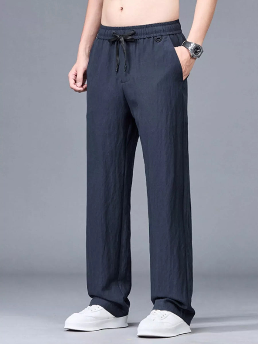 Navy blue casual lightweight trousers with drawstring waist and pockets.