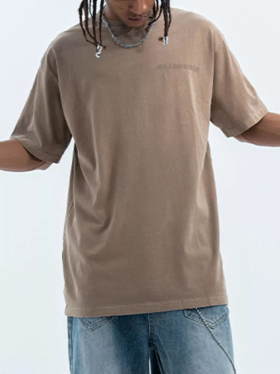 Brown oversized graphic tee with subtle chest print, 100% cotton, short sleeves
