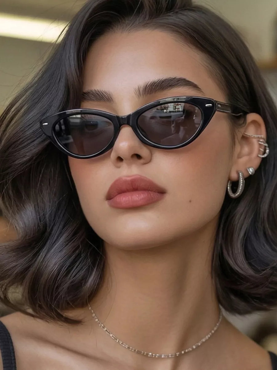 sunglasses in black featuring UV400 protection and cat-eye fit