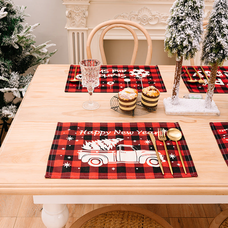 Festive plaid placemat with white truck and Christmas tree, Happy New Year text.