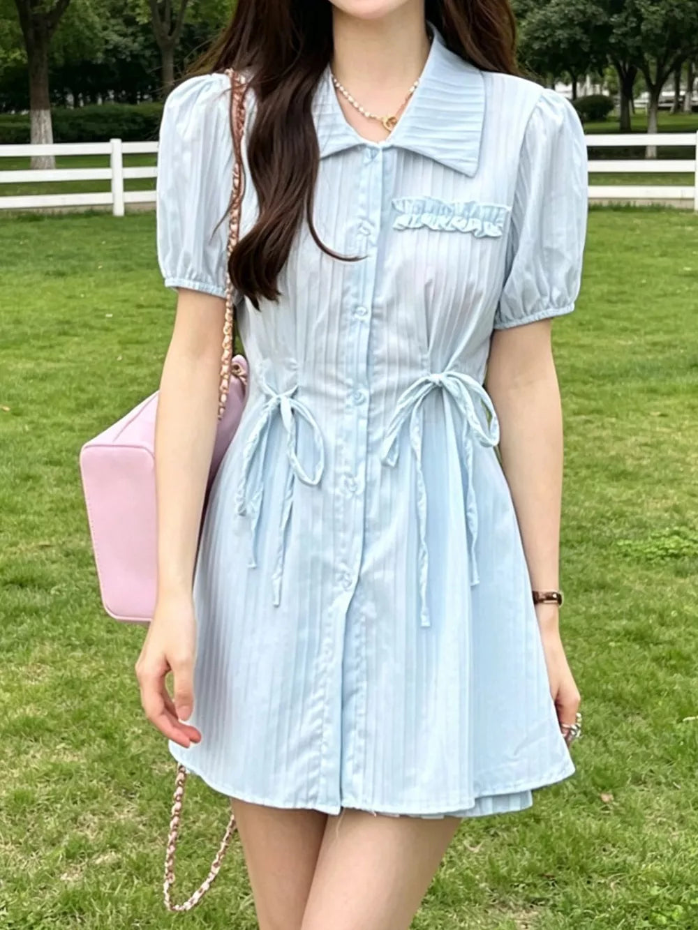 Light blue ruffled button-down mini dress with adjustable ties and puff sleeves