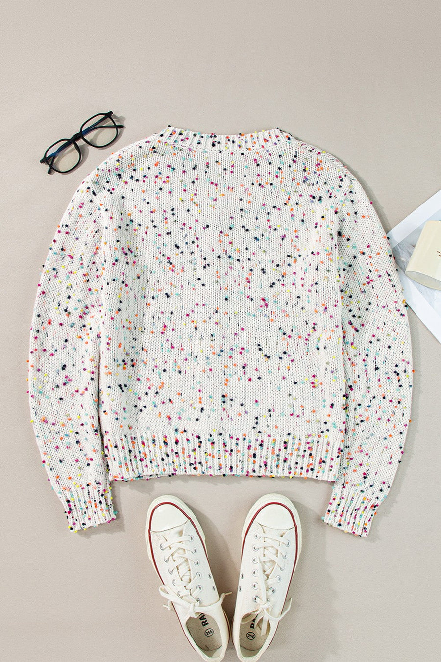 White confetti knit button-up cardigan with a crew neck and long sleeves.