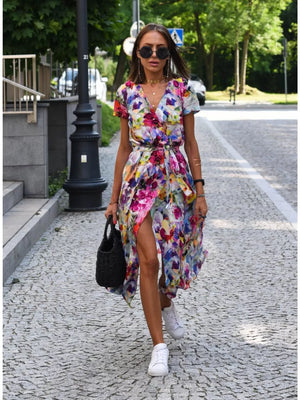 Wrap dress with vibrant floral print, V-neck, short sleeves, and a high slit.