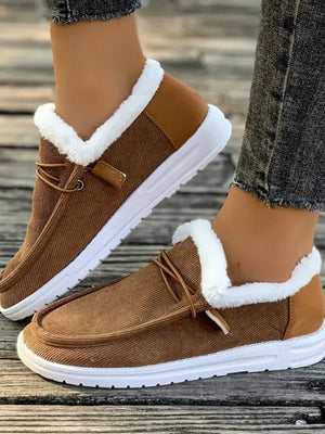 Brown corduroy slip-on sneakers with white faux fur lining and tan heel detail.