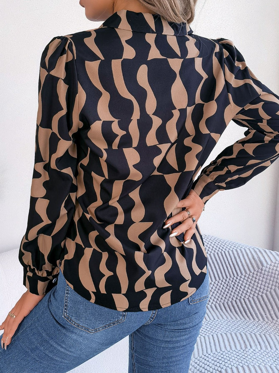 Black and camel abstract wave print silk-touch blouse with puff sleeves.