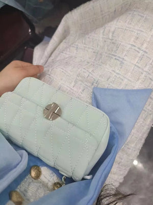 Mini quilted flap chain bag in light green with diamond stitching and silver hardware.