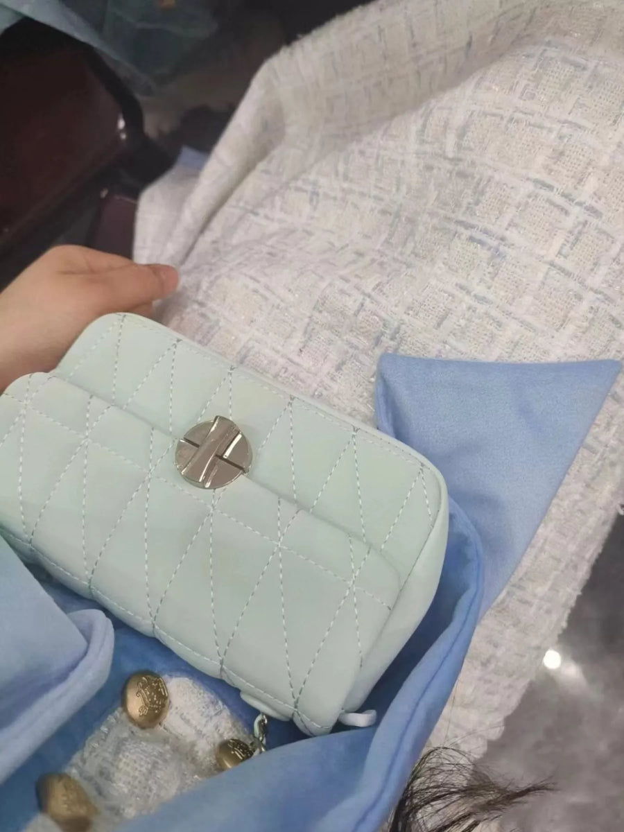 Mini quilted flap chain bag in light green with diamond stitching and silver hardware.