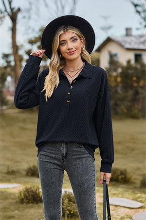 Textured knit polo shirt in dark blue with buttoned placket and long sleeves.