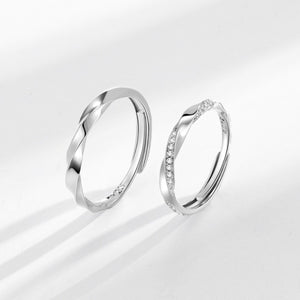 Adjustable sterling silver rings, one plain twisted band, one with pave zircon accents.
