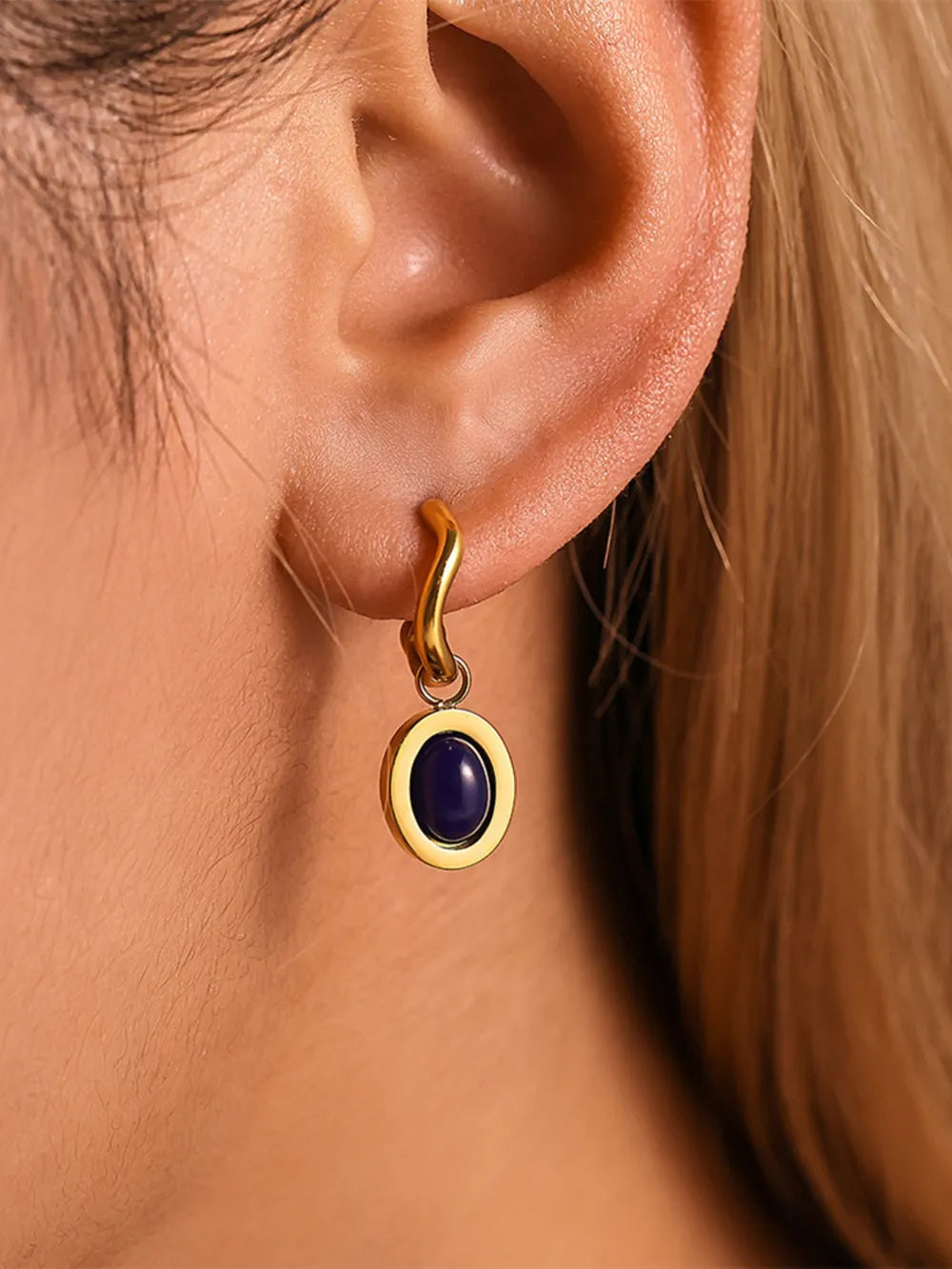 Sculptural hoop earrings with oval stone inset in golden kyanite.