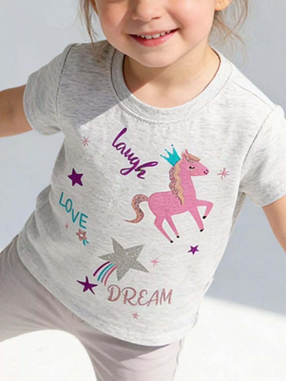 Toddler grey cotton t-shirt with pink unicorn graphic, crown, stars, and text. Relaxed fit, crew neck.
