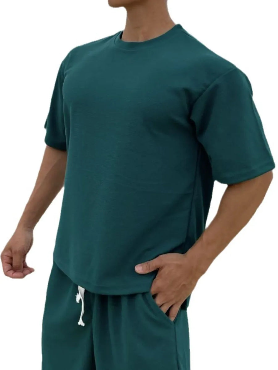 Oversized cotton tee in deep teal with drop shoulder and crew neck.