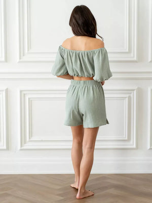 Green cotton off-shoulder cropped top and shorts set with elastic waistband and puff sleeves.