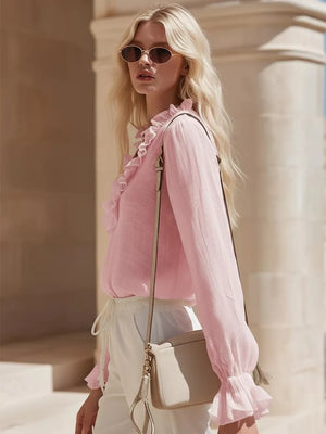 Pink V-neck maternity shirt with ruffled neckline and cuffs.
