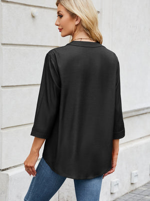 Black utility-pocket denim henley blouse with 3/4 sleeves and a curved hem.