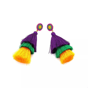 Vibrant layered tassel earrings in purple, green, and yellow with beaded tops.