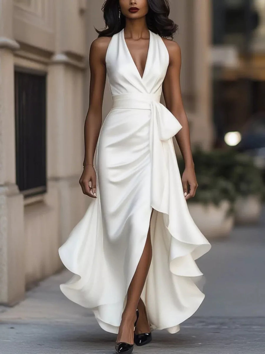 White halter maxi dress with ruffled asymmetrical hem and bow detail