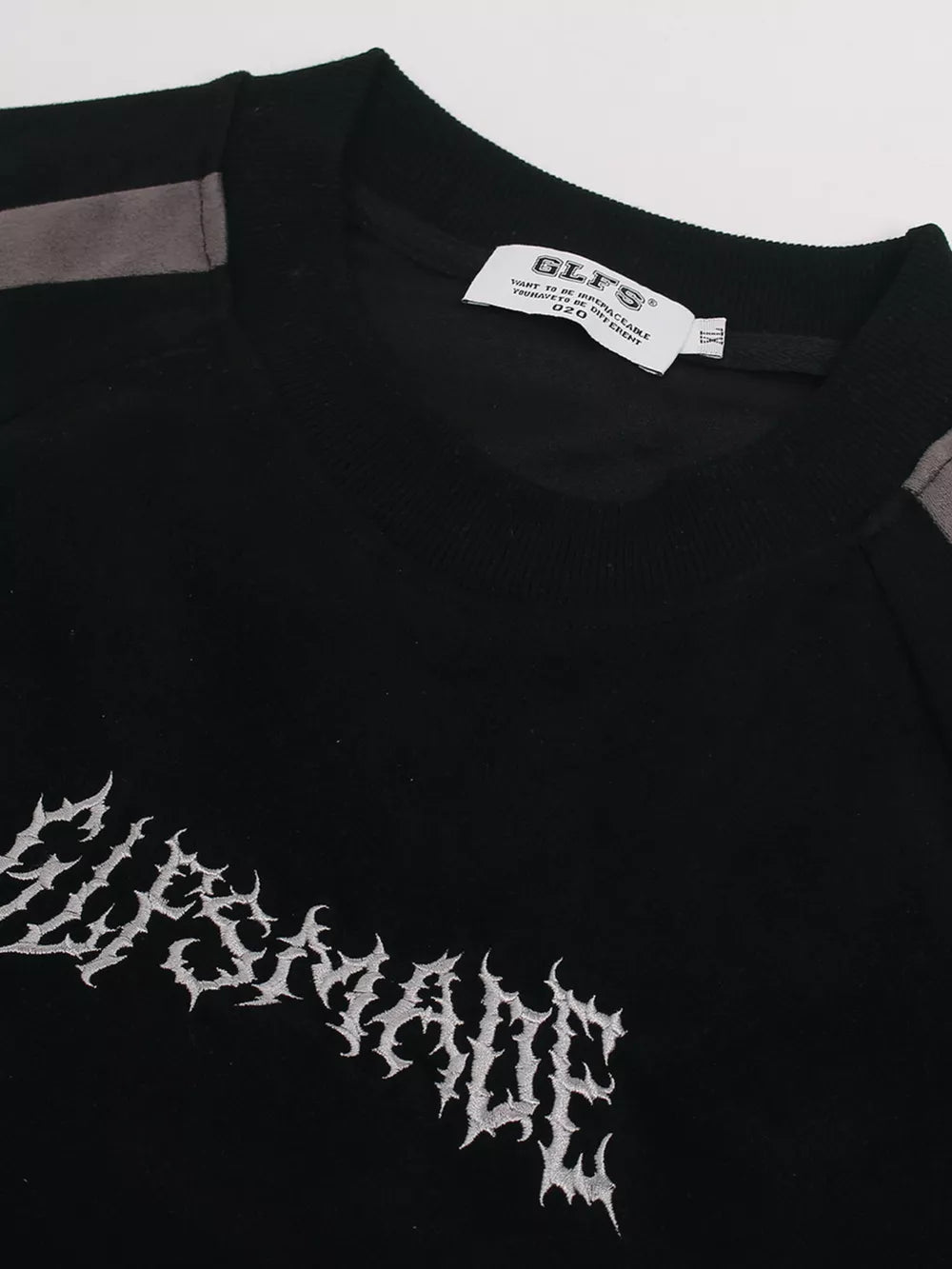 Black athletic t-shirt with embroidered graphic and grey shoulder details.