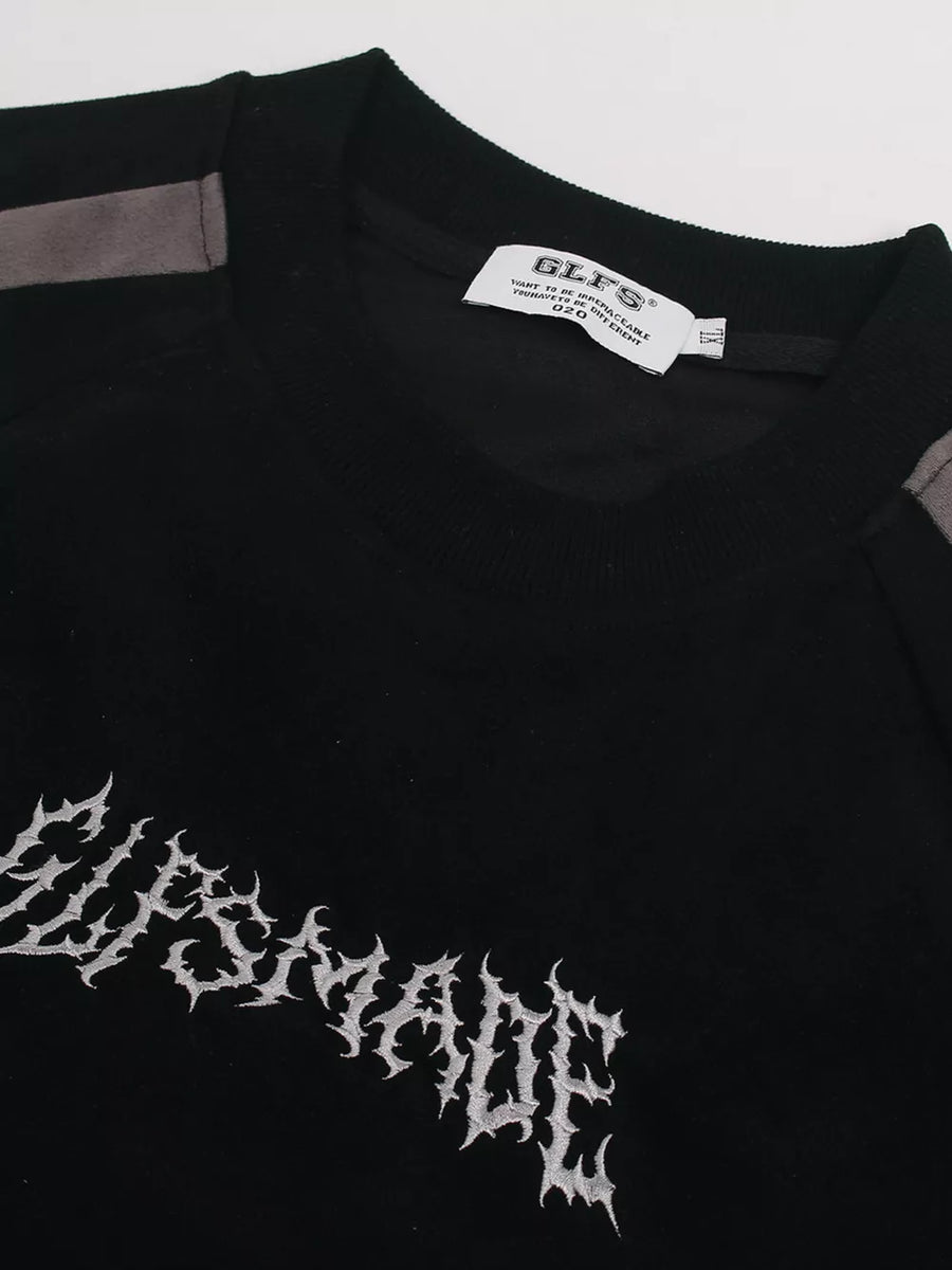Black athletic t-shirt with embroidered graphic and grey shoulder details.
