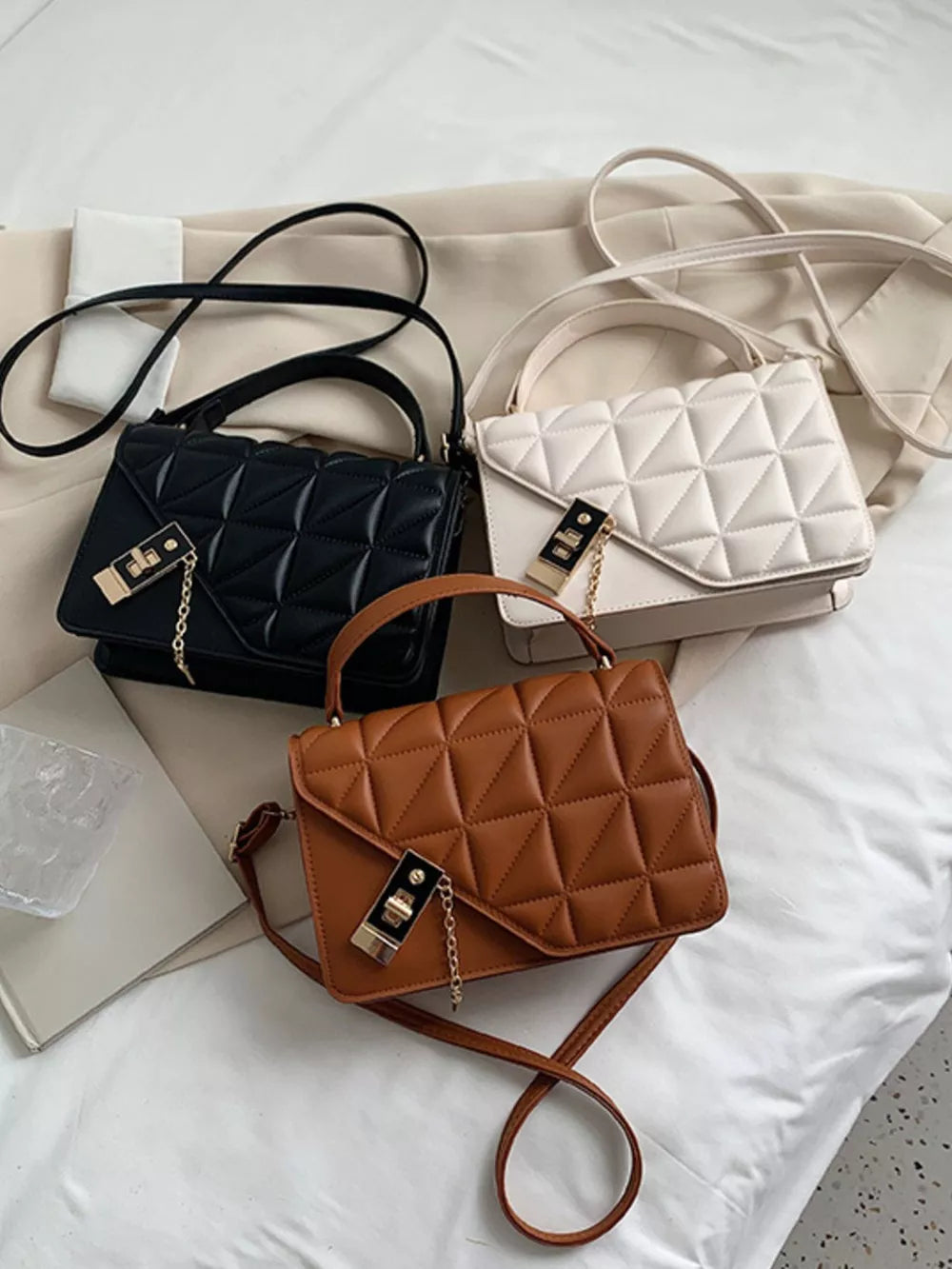 Diamond quilted PU leather crossbody bag in black, caramel, and beige white with gold chain detail.