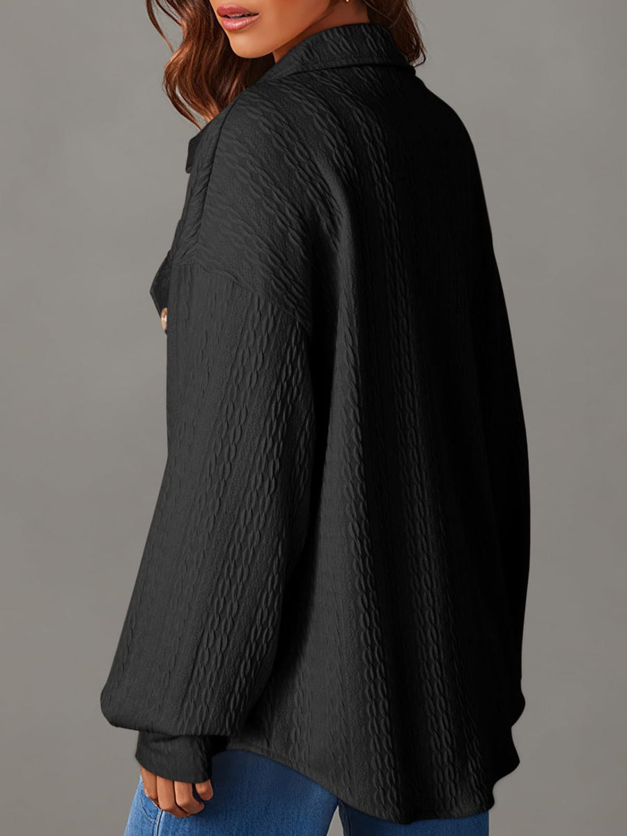 Black textured oversized button-down shacket with a collared neckline and long sleeves.