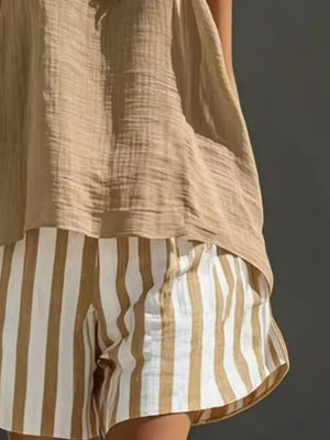 Striped shorts in white and tan with a beige gauze tank top.