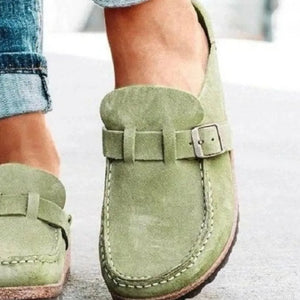Sage suede buckle mule loafers with contrast stitching and a silver buckle detail.