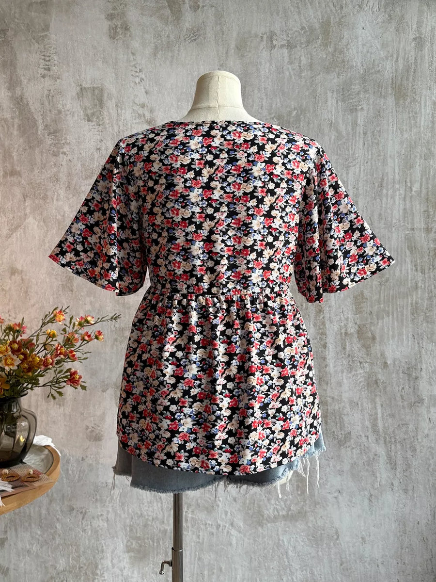 Black floral V-neck blouse with short sleeves and cinched waist