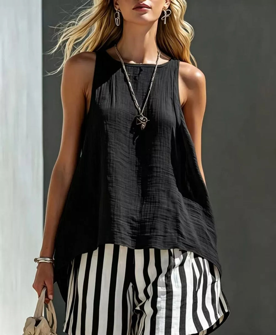 Black sleeveless textured tank top with a round neckline, paired with black and white striped shorts.