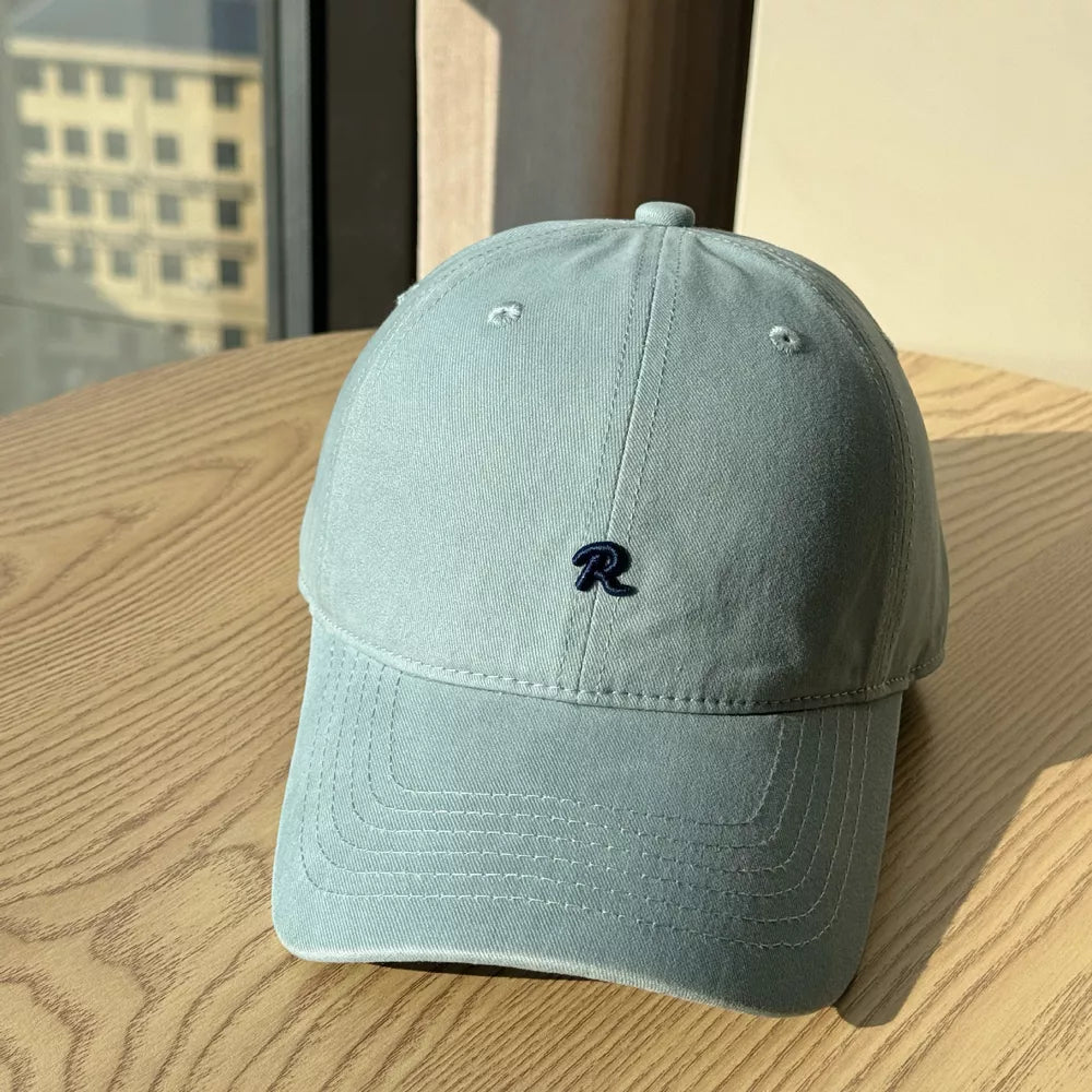 Light blue baseball cap with embroidered dark blue R letter detail