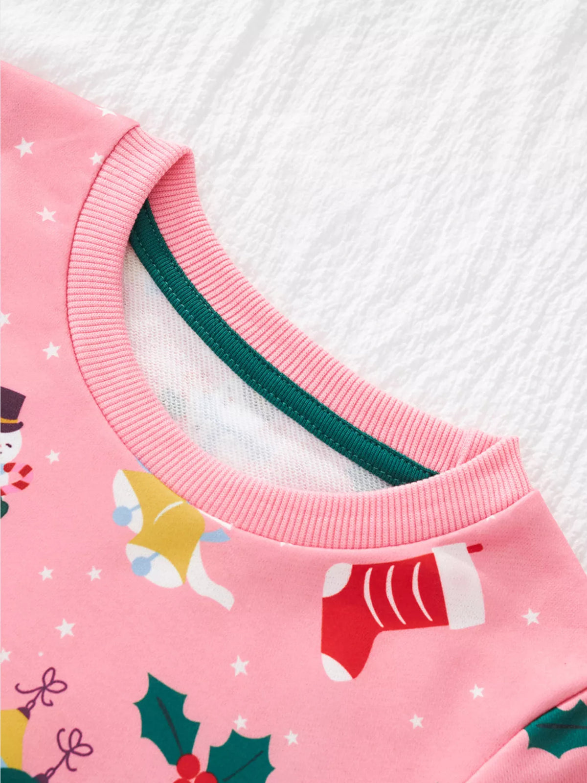 Pink crew neck sweatshirt with festive Christmas print and ribbed trim.