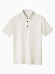 White textured pique polo shirt with refined collar and dark buttons.