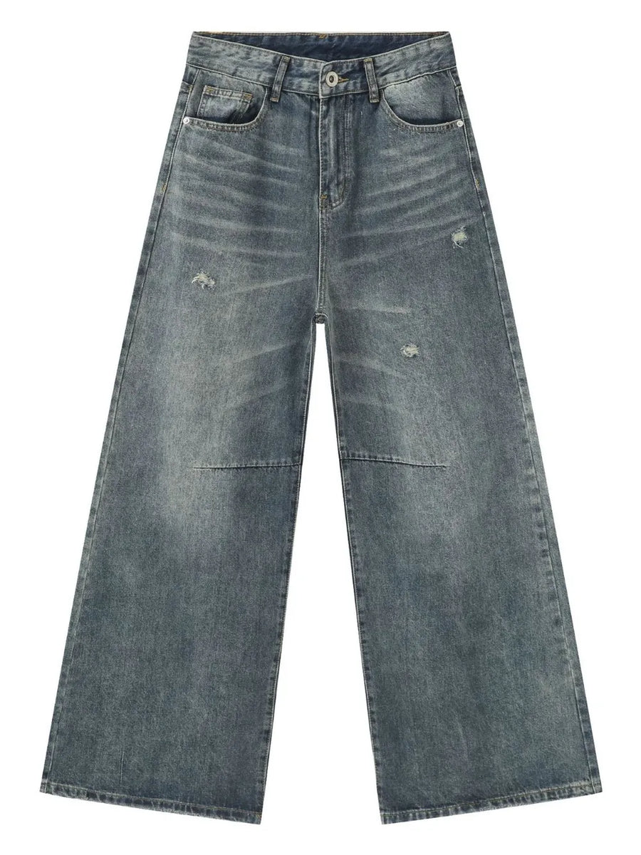 Distressed edge wide-leg jeans in medium wash denim with a relaxed fit.