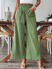 Green textured gauze palazzo trousers with pockets and elastic waist.