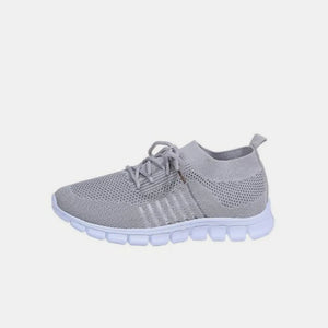 Gray knit runner sneakers with ribbed lace-up detail and white sole.
