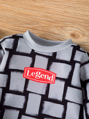 Children's grey long sleeve top with block pattern and red "Legend" graphic.