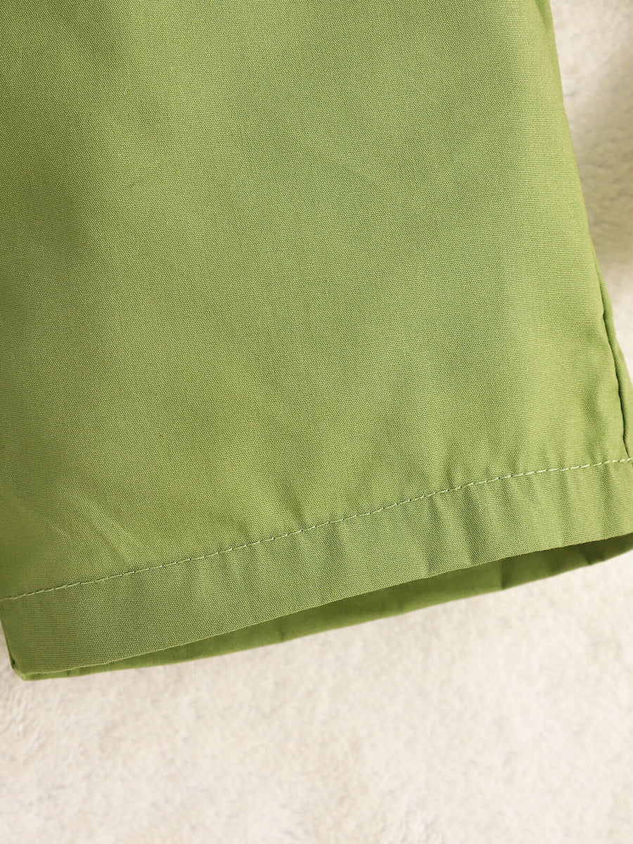 Green cotton baby shorts with stitched hem detail