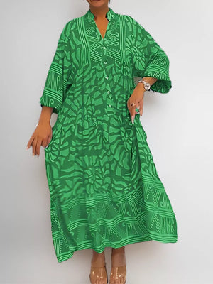 Green abstract print midi dress with V-neck and button front, 3/4 sleeves.